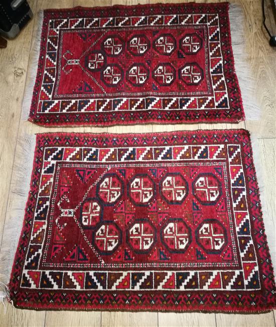 A pair of Afghan wool prayer rugs, red field with nine guls to the field 92 x 69cm